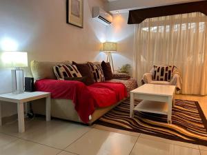a living room with a couch and a table at UMO Urban Suites in Ciudad de Malabo
