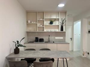 a kitchen with a table and chairs and a counter at Modern City Apartment in Larnaka
