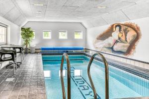 a swimming pool with a painting on the wall at BV333-Blavand-Almosetoften-10 in Blåvand