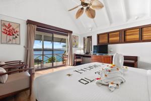 a bedroom with a bed with a view of the ocean at Iririki Island Resort & Spa in Port Vila