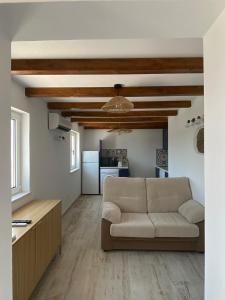 a living room with a couch and a kitchen at Sunny Aljezur da Misericórdia, Aljezur, Costa Vicentina in Aljezur