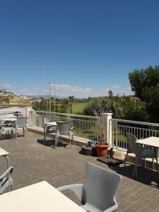 a patio with tables and chairs on a balcony at Casa Maria with Pool, Terace & Amazing View - near Beach, Golf, Town & Relax - 1-6 Guests in Rojales