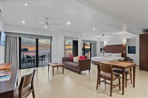 a hotel room with a bed and a table and chairs at Iririki Island Resort & Spa in Port Vila
