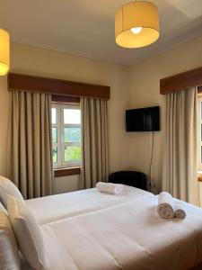 a hotel room with two beds and a window at Casas do Souto in Lousada +160 photos