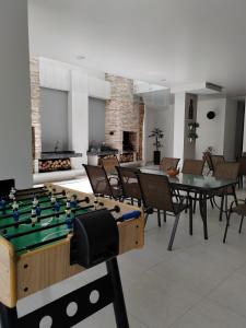 a room with a pool table and tables and chairs at 2p Departamento en Torres Ventura in Cochabamba