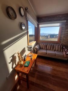 a living room with a couch and a table at Cabañas Antu Kuyen Patagónica in Puerto Natales