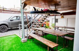 a picnic table with a surfboard on top of it at Palm Hostal in Iquique