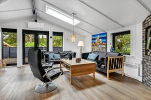 a living room with a couch and a table at BV339-Blavand-Toldbodvej-28 in Blåvand