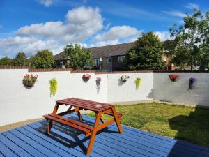 a wooden picnic table sitting on a deck at Lovely Private Room in Dublin