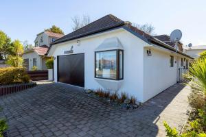 a white house with a driveway at Fantail's Landing in Taupo