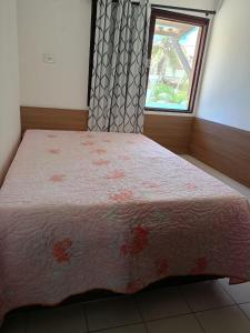 a bedroom with a large bed with a window at Casa disponível para esse final de semana, Barramar House in Barra de São Miguel +15 photos