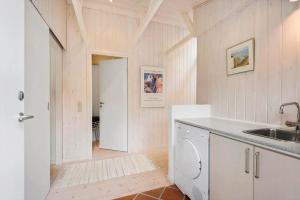 a kitchen with a sink and a washing machine at BV325-Blavand-Tvaervaenget-8 in Blåvand +22 photos