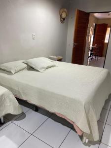 a bedroom with a large bed in a room at Kitnet com quarto amplo e cozinha Santarém- Pará in Santarém