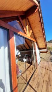 an outside view of a house with a large glass window at Chalé Garden da Mantiqueira in Monte Verde +7 photos