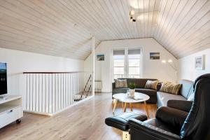 a living room with a couch and a table at 0440-Romo-Vestergade-227-Ap-17 in Sønderby