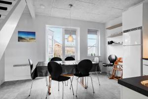 a dining room with a black table and chairs at 0440-Romo-Vestergade-227-Ap-17 in Sønderby