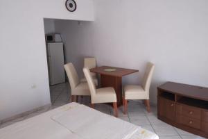 a room with a table and chairs and a kitchen at Apartments with WiFi Postup, Peljesac - 23780 in Orebić