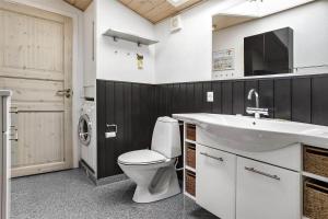 a bathroom with a toilet and a sink at 13383-Asnaes-Glentevej-15 in Asnæs +14 photos