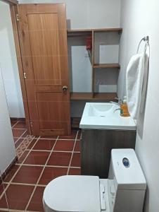 a small bathroom with a toilet and a sink at Posada San Miguel in Orocué