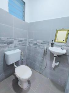 a bathroom with a toilet and a sink at Puteri Duyong Homestay in Malacca +12 photos