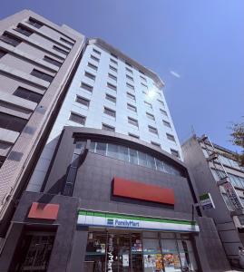 a tall building with a red sign on it at HOTEL AMANEK Osaka Namba in Osaka +50 photos