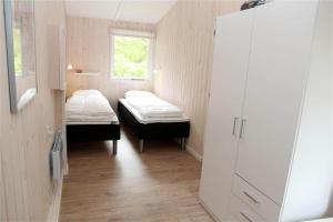 a small room with two beds and a window at 0362-Romo-Skovskaden-17 in Mølby