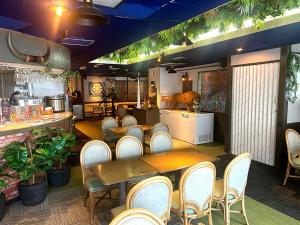 a restaurant with a table and chairs and a counter at Diamond Shiga in Yamanouchi