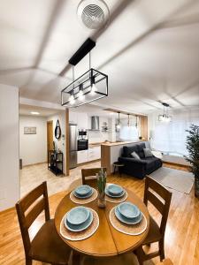 a dining room and living room with a table and chairs at San Marcos in Ribadeo +32 photos