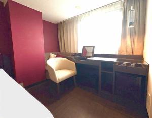 a room with a desk with a computer and a chair at HOTEL AMANEK Osaka Namba in Osaka