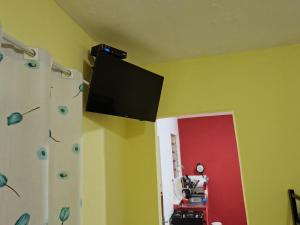 a flat screen tv on the wall of a room at Yellow Hostel in São Paulo +7 photos
