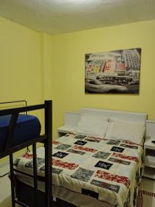 a bedroom with a bed and a poster on the wall at Yellow Hostel in São Paulo