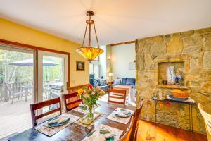 a dining room with a stone wall and a table and chairs at Game Room, Hot Tub! Year-Round Dover Retreat in West Dover
