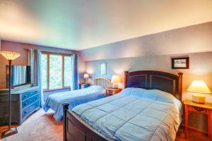 a bedroom with two beds and a television in it at Game Room, Hot Tub! Year-Round Dover Retreat in West Dover