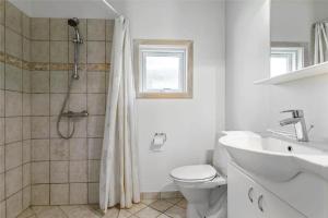 a bathroom with a shower and a toilet and a sink at 13319-Hojby-Petersvej-4 in Højby +14 photos