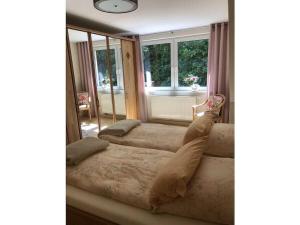 a living room with two beds and a window at Schwarzatal Trippstein 2 in Schwarzburg