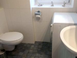 a bathroom with a toilet and a sink at 1 Rehfeld family in Dresden +12 photos