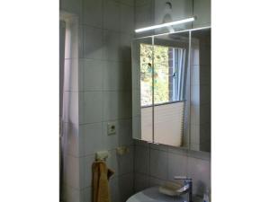 a bathroom with a sink and a mirror at Holiday home in Rügeband with swimming pool  +29 photos