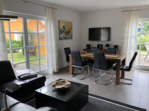a living room with a wooden table and chairs at Holiday home in Prerow with swimming pool in Prerow