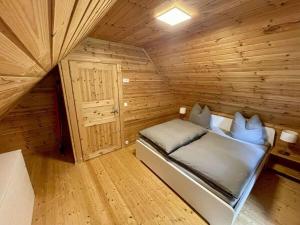 a small room with a bed in a wooden cabin at 2 - Anett Pollok in Neuruppin +22 photos