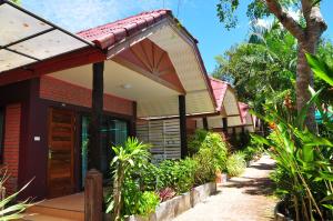 a house with a red roof and some plants at Green View Village Resort in Ao Nang Beach