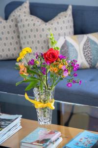 a vase filled with flowers sitting on a table at Venice Beach Cottage Retreat in Los Angeles