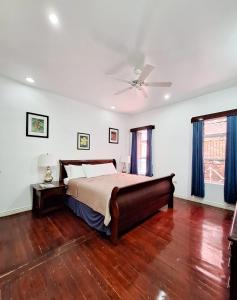 a bedroom with a bed and a ceiling fan at Harbour View Boutique Hotel & Wellness Retreat in Belize City