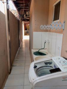 a bathroom with two washing machines in a room at Athenas empreendimentos in Campo Grande