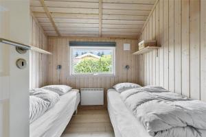 a room with three beds in it with a window at 13329-Asnaes-Leifavej-Vestre-11 in Asnæs