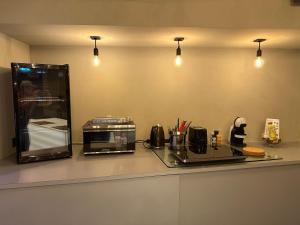 a kitchen counter with a coffee maker and a microwave at soulfactory Gewölbe in Neu-Ulm
