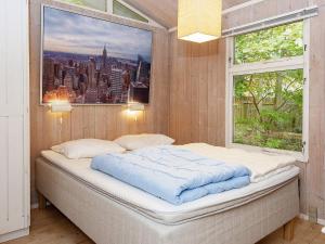 a bed in a room with a window at 8 person holiday home in Rønde-By Traum in Rønde