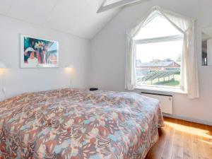 a bedroom with a bed and a large window at 6 person holiday home in Hadsund-By Traum in Hadsund