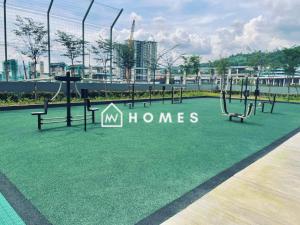 an empty playground in a park with benches and swings at Majestic Maxim 3Bedroom near UCSI MRT #28 in Cheras