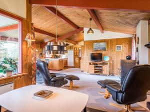 a living room with a table and chairs at 4 person holiday home in Nørre Nebel in Nørre Nebel