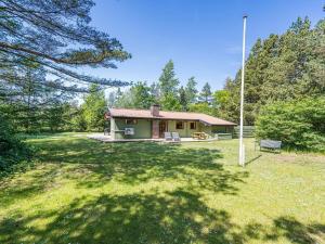 a small house in the middle of a yard at 4 person holiday home in Nørre Nebel in Nørre Nebel